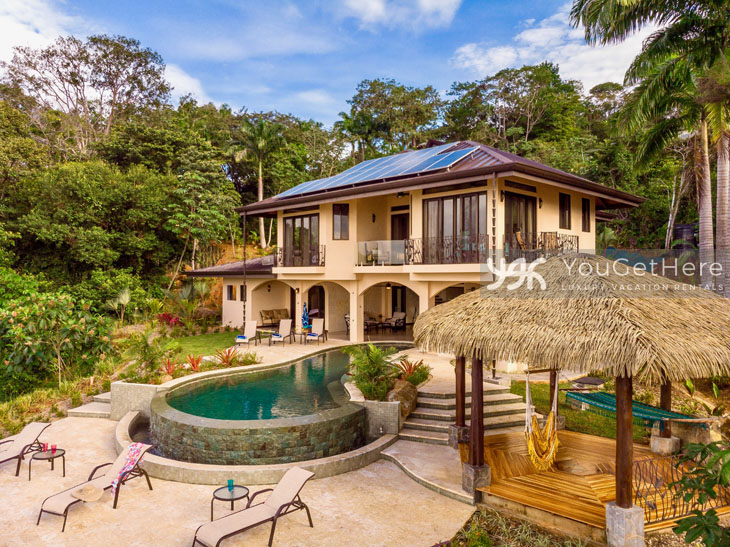 Ballena Royale Luxury Vacation Villa backyard view of pool and palapa.