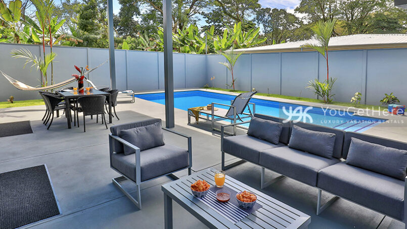 Large outdoor sofa and chair near pool deck at Bella Vita vacation rental in Uvita.