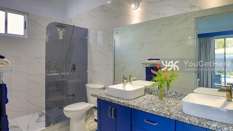 Spacious bathroom with dual sinks and large rainfall shower in Bella Vita vacation house.