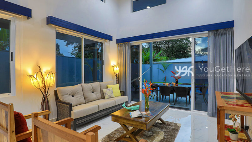 Comfortable living room with lots of windows to let in natural light at Bella Vita Costa Rica.