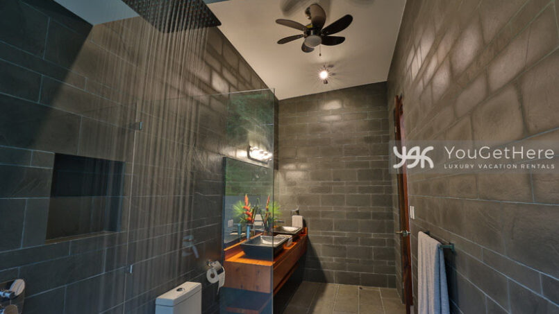 Beautifully tiled guest bathroom with overhead rainfall showerhead at Villa Oro Verde Costa Rica.