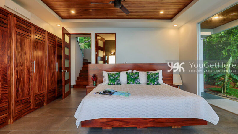 Large bed and lovely wood closets in guest bedroom of Villa Oro Verde Luxury Holiday Home.