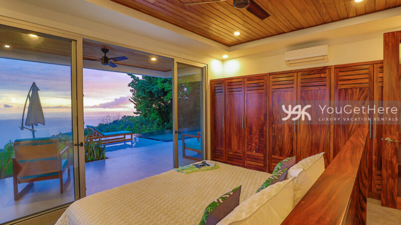 Beautiful wooden closet and headboard in Villa Oro Verde Guest Suite with patio on pool deck.