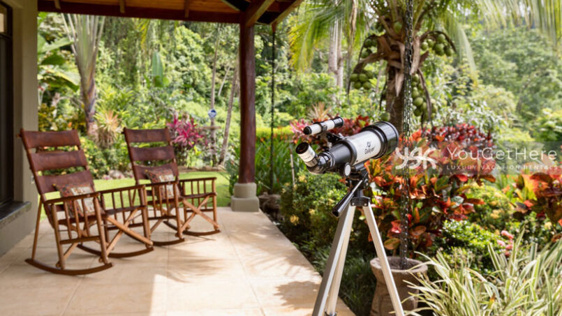 Outdoor patio with locally made rocking chairs and telescope for star gazing at Villa Koora.