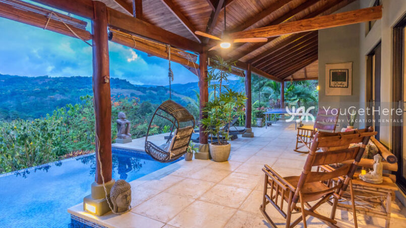Large patio with tropical potted plants and custom local rocking chairs at Villa Koora.