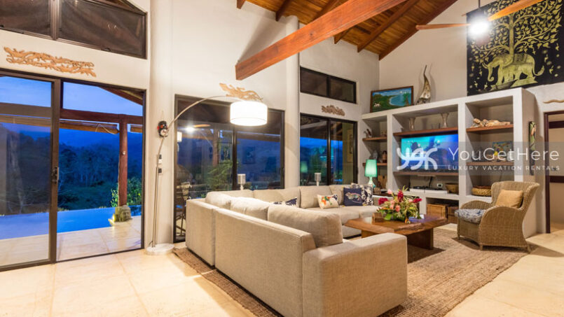 Sleek comfortable living room design with ample seating and TV at Villa Koora Costa Rica.