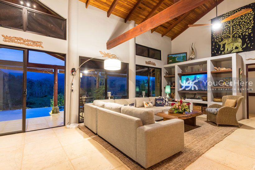 Sleek comfortable living room design with ample seating and TV at Villa Koora Costa Rica.