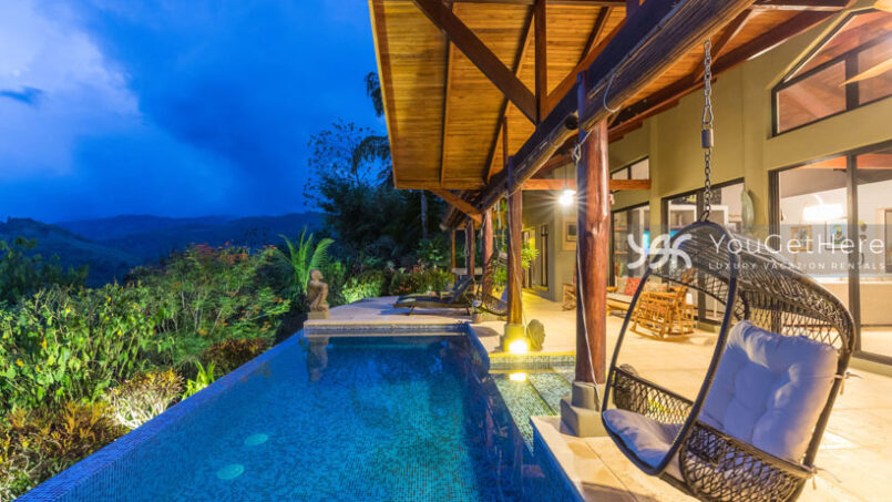 Villa Koora pool at night with beautiful lighting around deck and in landscaping.