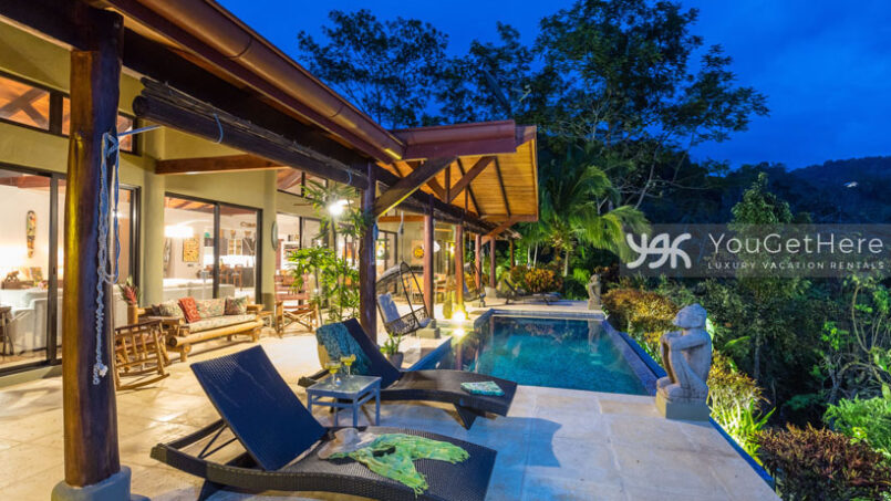 Nighttime view of Villa Koora pool deck with lighted patio.