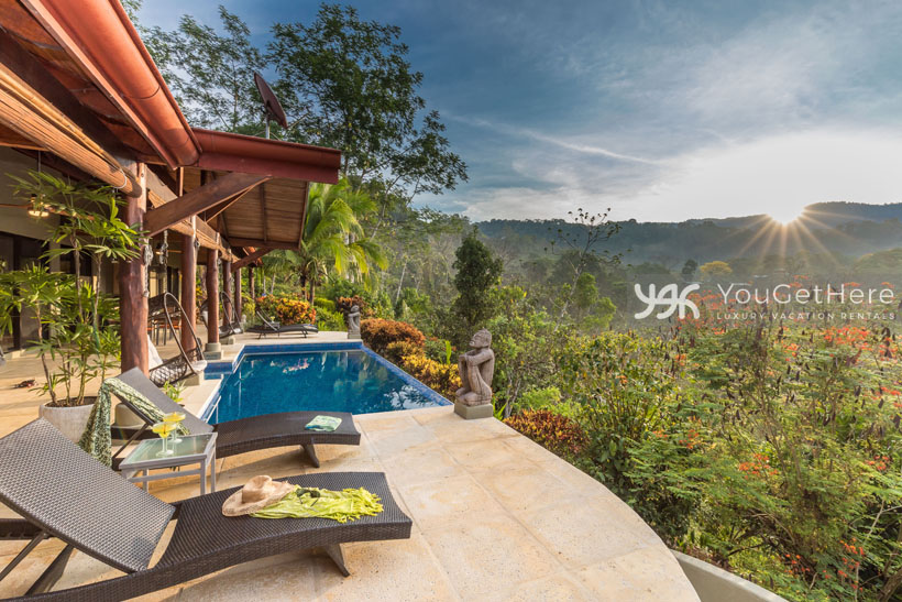 Sun setting at Villa Koora pool deck on a beautiful blue sky afternoon.
