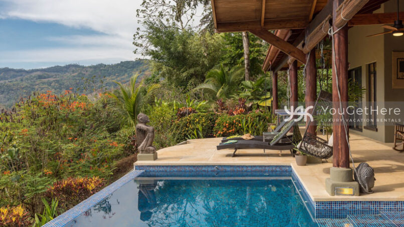 Infinity pool with stone statue decor at Villa Koora Costa Rica.