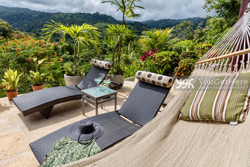 Tons of comfortable seating options with views surround the pool at Villa Koora Holiday rental in Costa Rica.