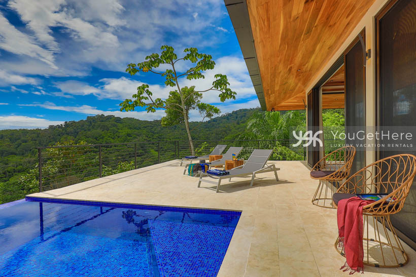 Outdoor pool lounge chairs on the deck at Villa Dalu Vacation Home.
