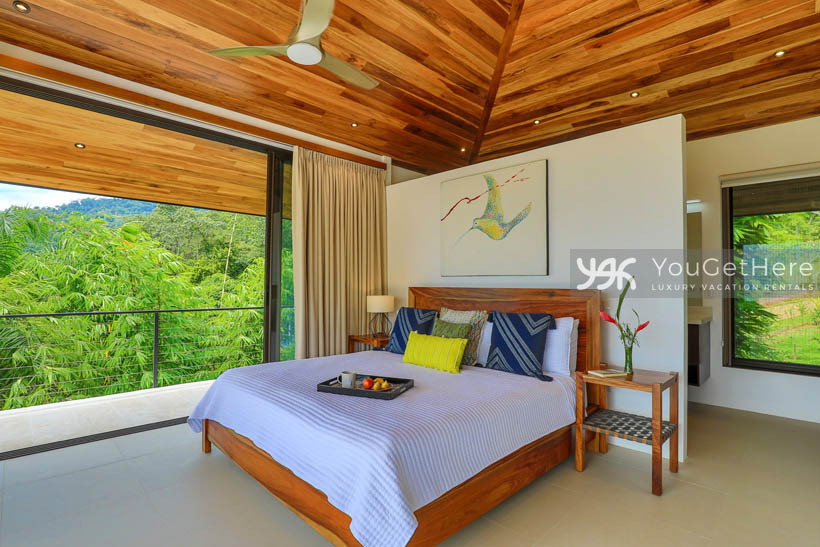 Wall to wall sliders open onto private balcony from master bedroom at Villa Dalu Costa Rica.