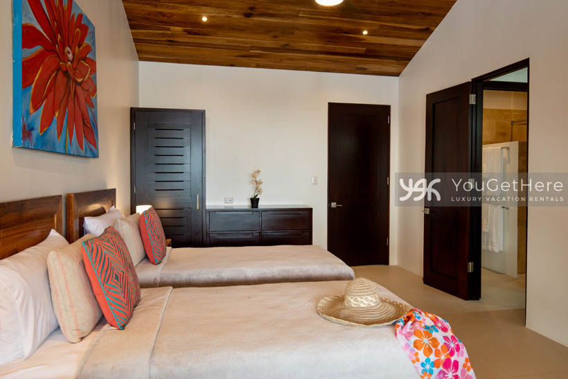 Villa Dalu guest bedroom with two beds and ensuite bath.
