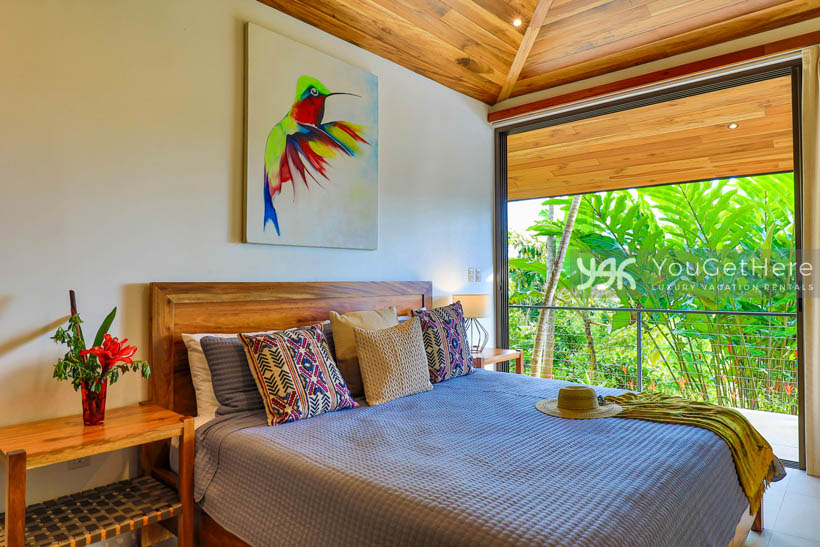 Villa Dalu luxury villa guest bedroom with colorful tropical flowers and art.