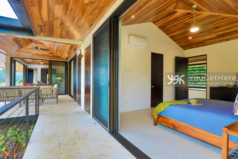 Outdoor patio and disappearing slider door on guest bedroom at Villa Dalu.