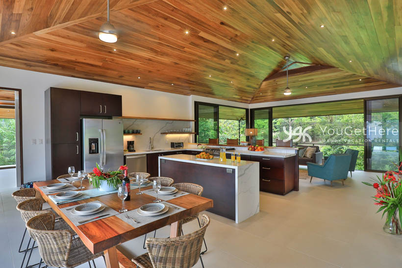 Indoor living spaces, kitchen and dining area at Villa Dalu vacation home in Costa Rica.