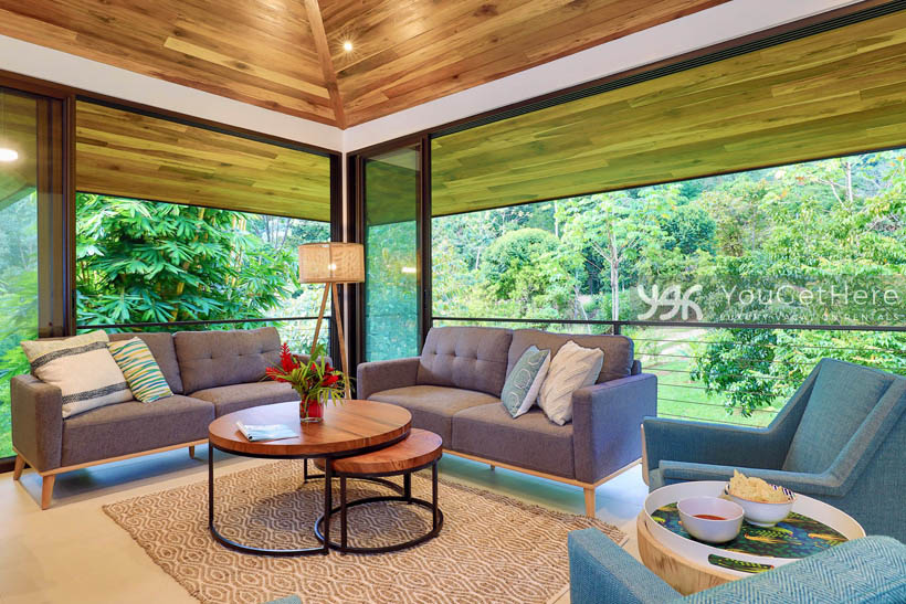 Villa Dalu lovely living area with comfortable sofas and chairs and massive views of rainforest.