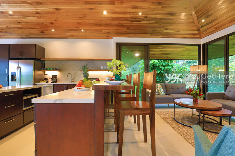 Villa Dalu sleek and modern kitchen with raised bar and four barstools.