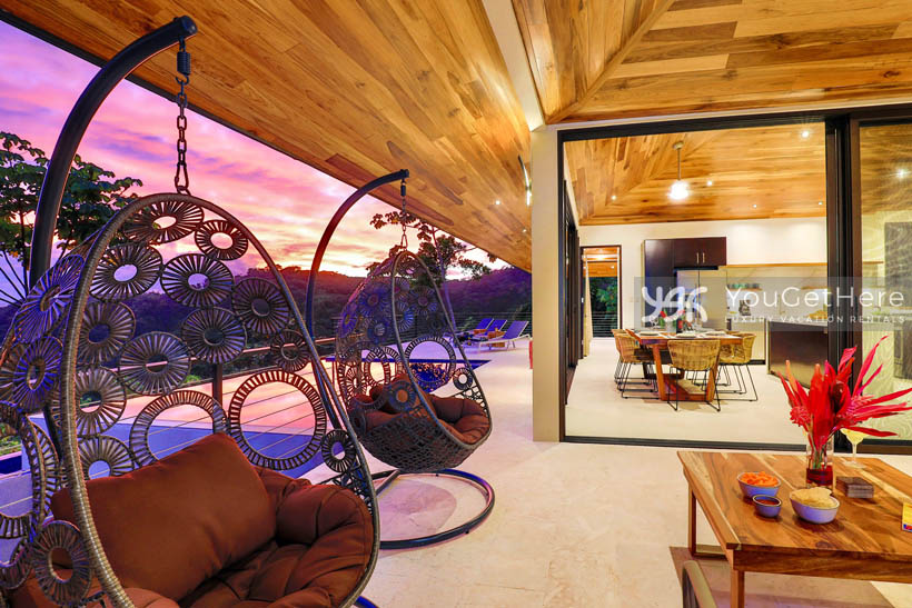 Outdoor seating, hanging swing chairs and pool loungers provide ample seating at Villa Dalu patio and pool deck.