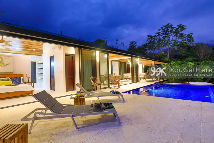 Nighttime lighting view of the pool and patio at Villa Dalu.