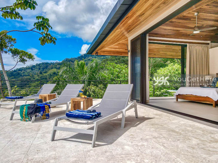 Pool deck lounge chairs outside of the primary bedroom at Villa Dalu Luxury Villa in Costa Rica.