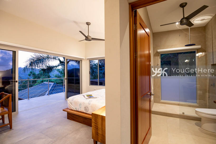 Tulu Azul Costa Rica guest bedroom with ensuite bathroom and large outdoor balcony with ocean view.