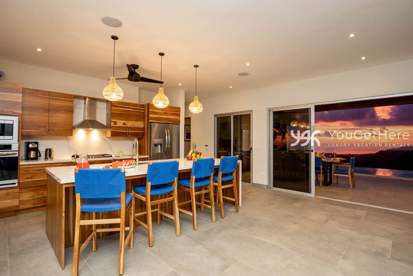 Tulu Azul Costa Rica sunset over ocean from inside looking out huge slider door.