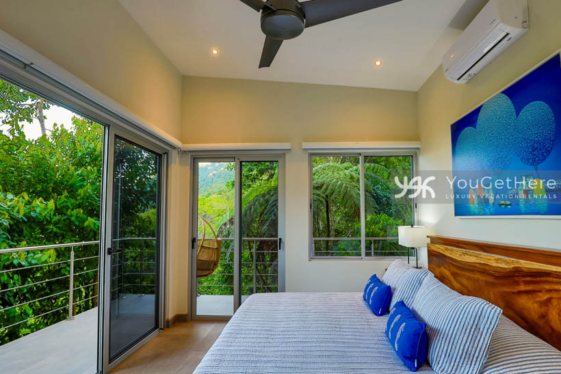 Tulu Azul Costa Rica guest suite with king bed and two sliders onto wrap around balcony.