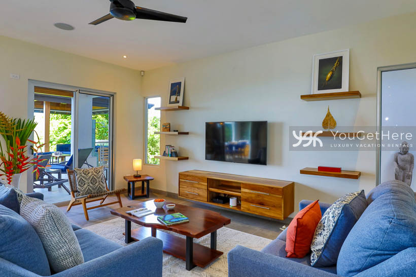 Tulu Azul Costa Rica comfortable sofa and chair with beautiful decor and wall mounted TV.