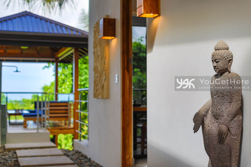 Tulu Azul Costa Rica exquisite decor details stone sculptures and beautiful sconces providing outdoor walkway wall lighting.