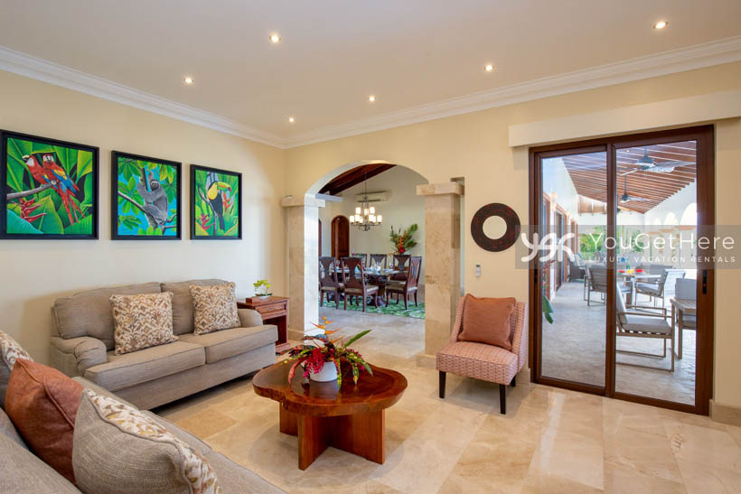 Vista Encanto Costa Rica living room area with tropical art and comfortable over-sized sofas and custom wood coffee table.