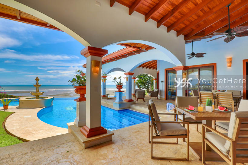 Vista Encanto Costa Rica outdoor covered dining table with ceiling fan overhead and ocean view.