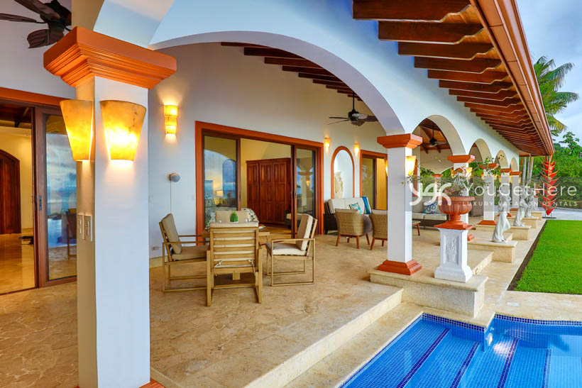 Vista Encanto Costa Rica lovely architecture with arched ceilings and stone sculptures lining patio.
