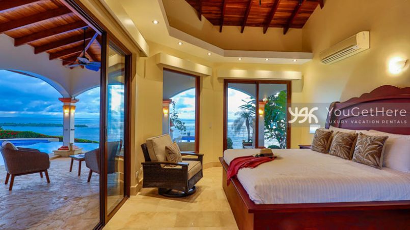 Vista Encanto Costa Rica bedroom King bed with slider doors that open onto patio and pool deck.