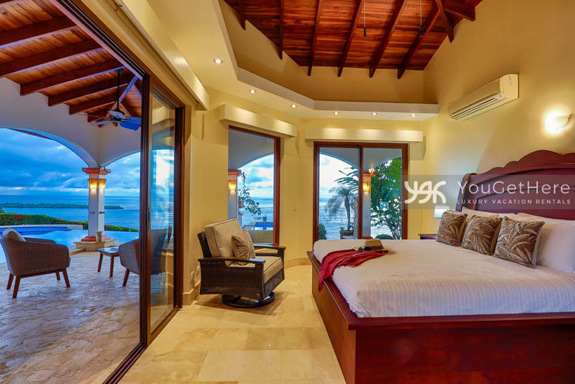 Vista Encanto Costa Rica bedroom King bed with slider doors that open onto patio and pool deck.