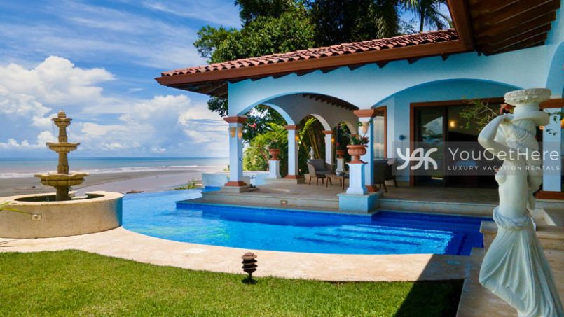 Vista Encanto Costa Rica patio archways and stone sculptures with view of fountain in pool.
