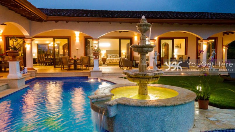 Vista Encanto Costa Rica outdoor patio arches and pool with lighted fountain.