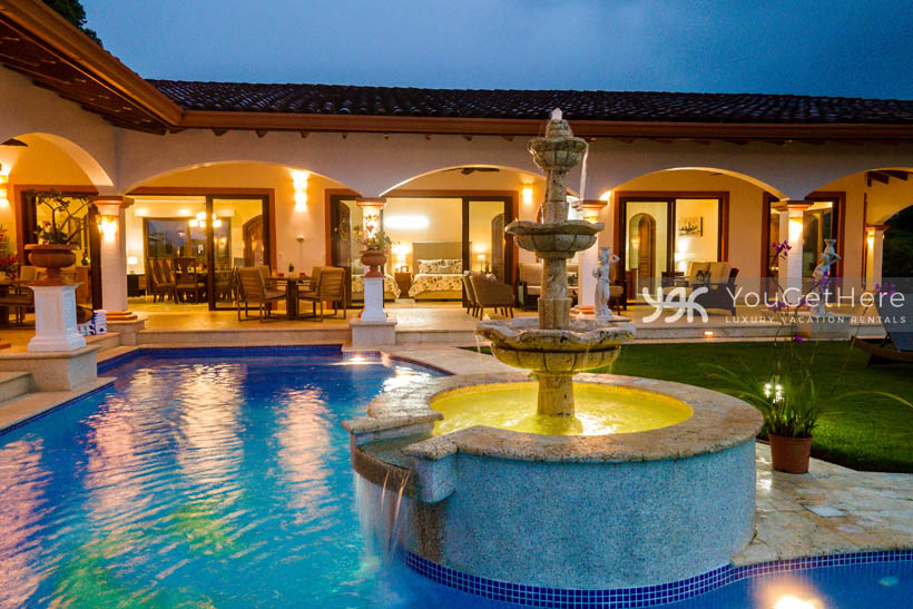 Vista Encanto Costa Rica outdoor patio arches and pool with lighted fountain.