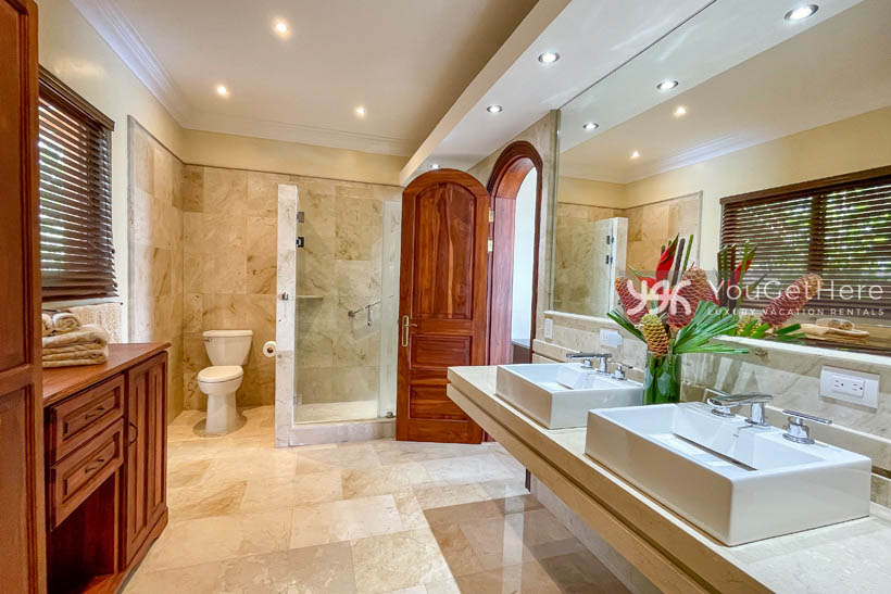 Vista Encanto Costa Rica Primary bathroom with wooden cabinetry and large closet.
