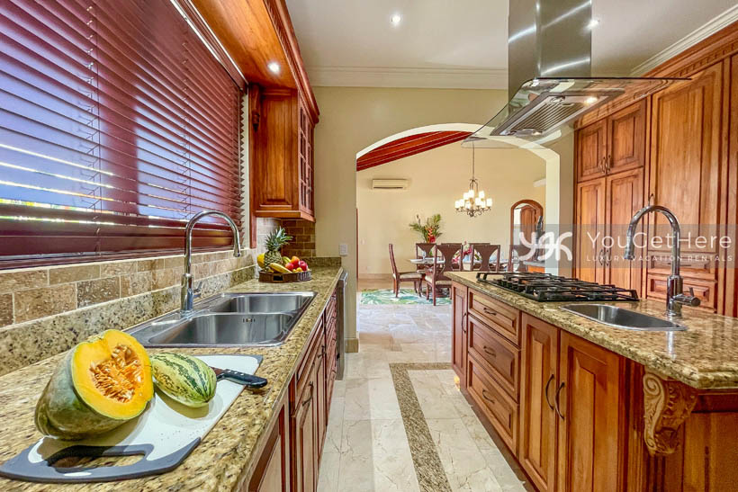 Vista Encanto Costa Rica kitchen with large stovetop and beautiful wood cabinetry.