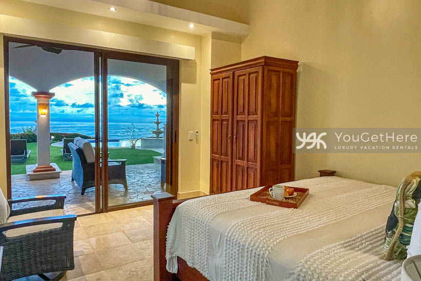Guest bedroom at Vista Encanto Costa Rica with pool and ocean views.