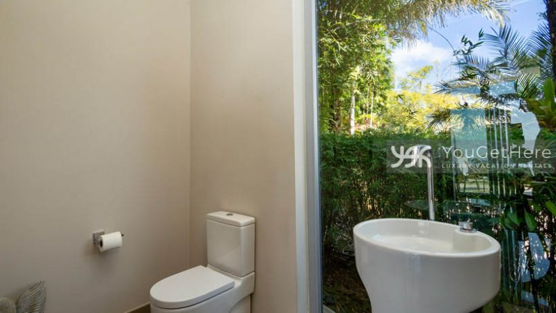 Meridian House Costa Rica guest bathroom with full wall window and privacy landscaping.