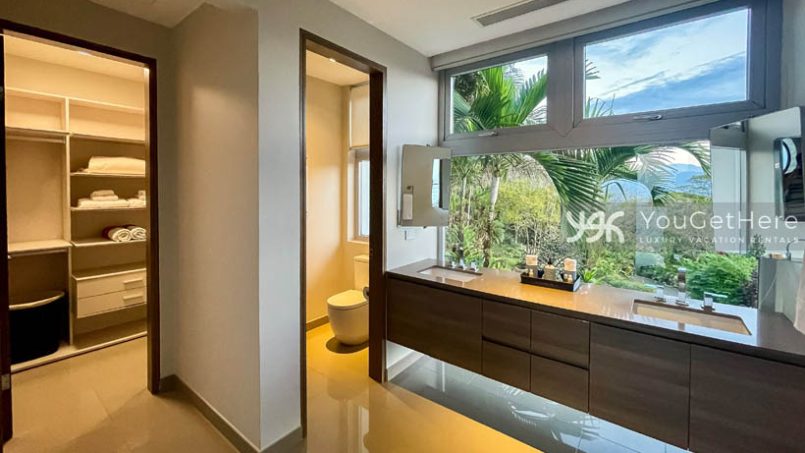 Huge modern primary bathroom of Meridian House Costa Rica with jungle views out window and walk in closet off the bath.