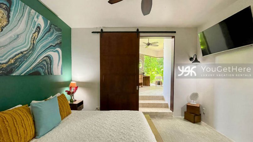 Lovely guest bedroom at the Jade House with beautiful art and a large king size bed.