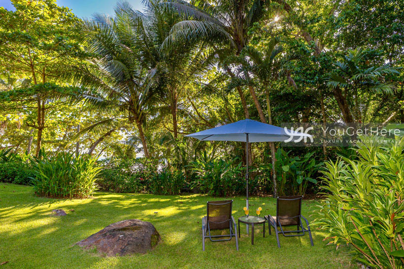 Caballitos del Mar Norte Backyard lounge area in landscaped garden setting.