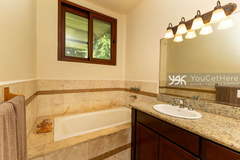 Caballitos del Mar Guest bath with full tub beachfront villa.