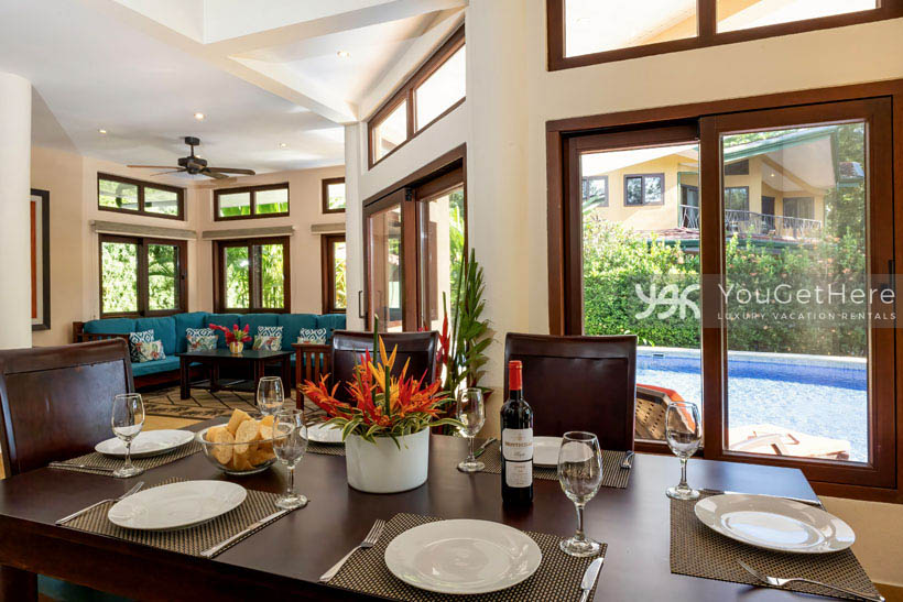 Caballitos del Mar Beachfront vacation rental dining room with view of the pool deck.