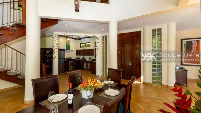 Caballitos del Mar Central dining room with house entryway and kitchen in open living space.